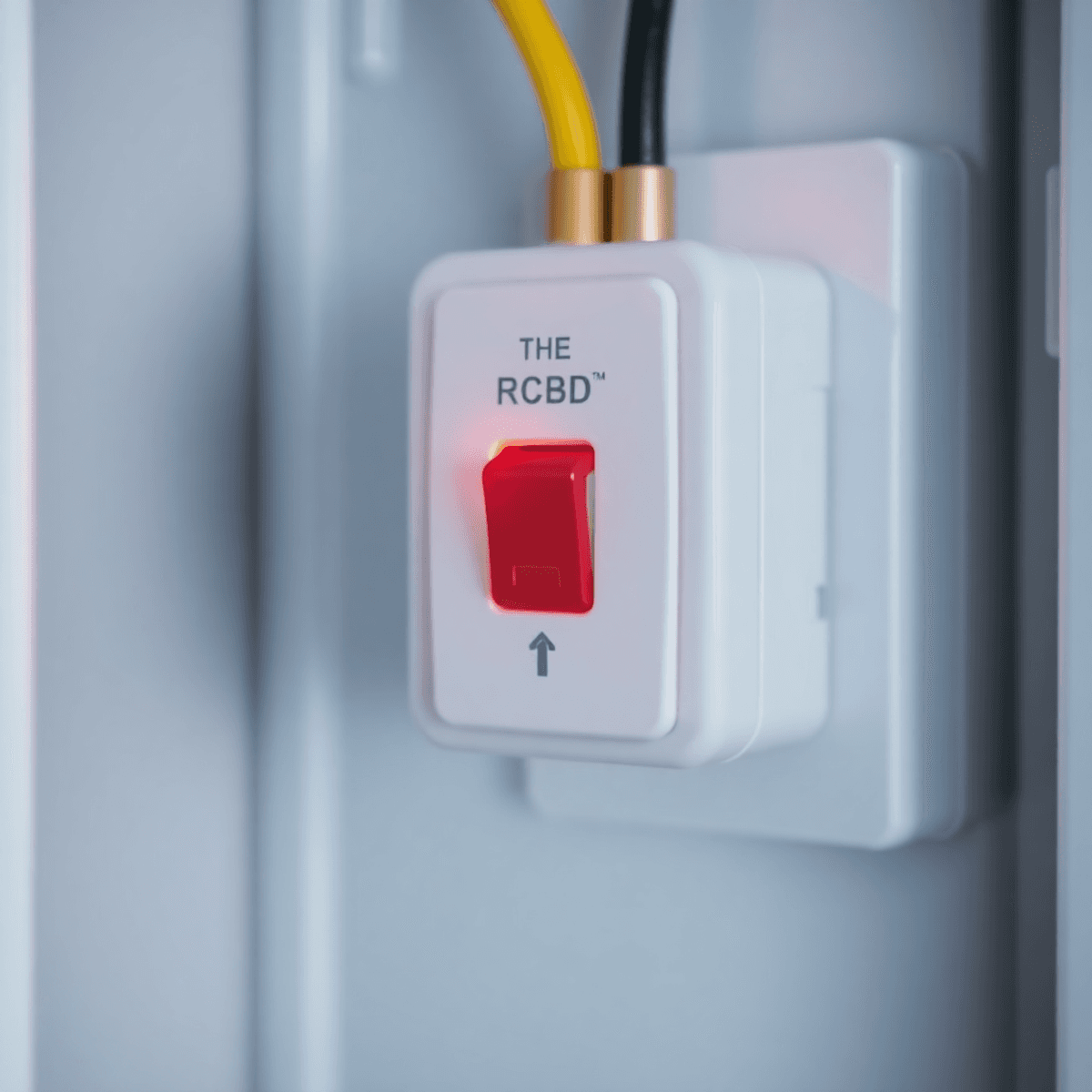 Close-up of a modern RCD switch glowing softly in an electrical panel, symbolizing safety and protection with a bright, clean background.